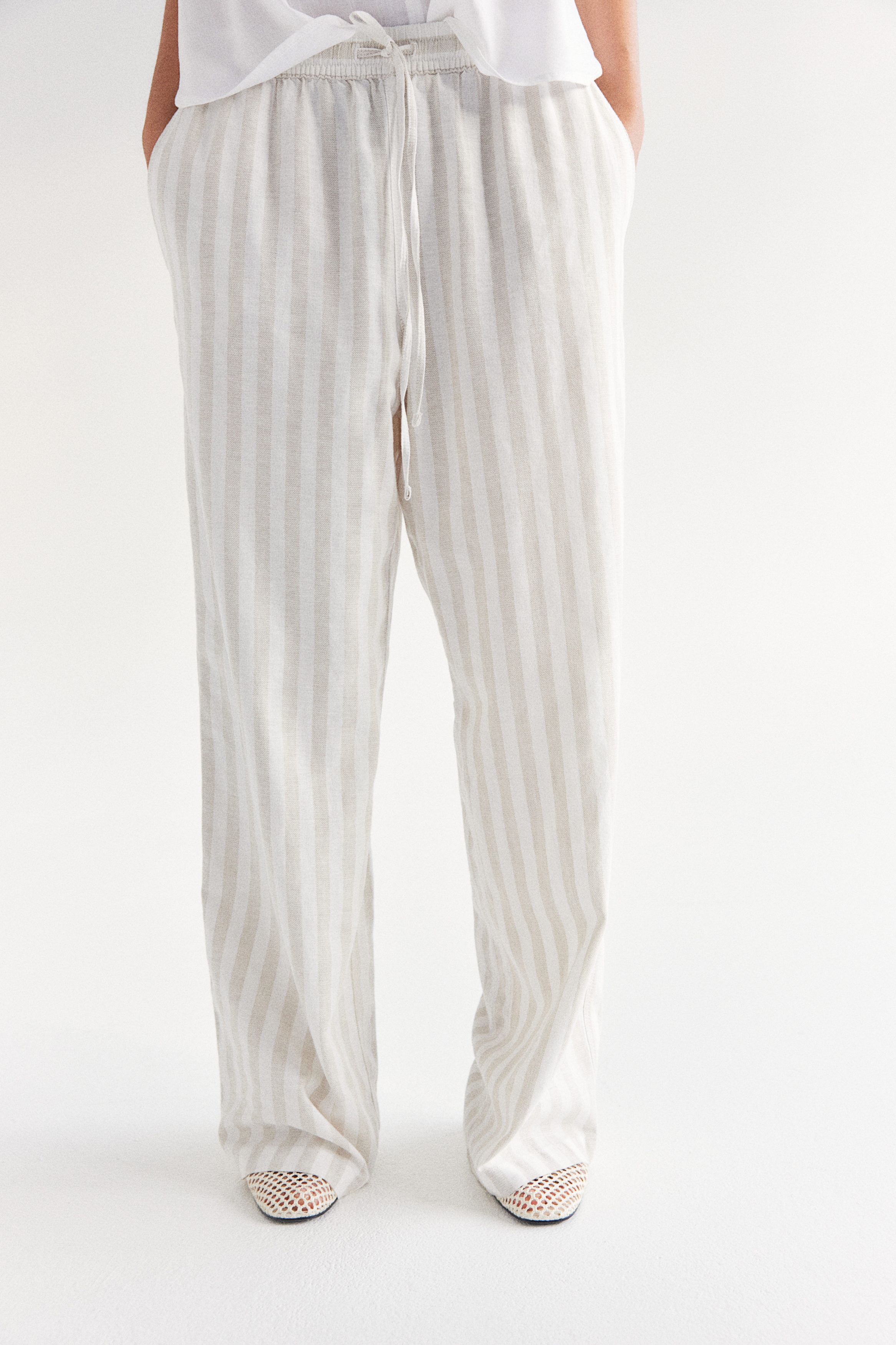 Buy Tapered linen-blend trousers online in Kuwait